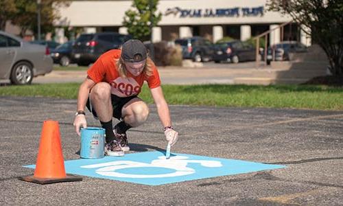 student painting on concrete 